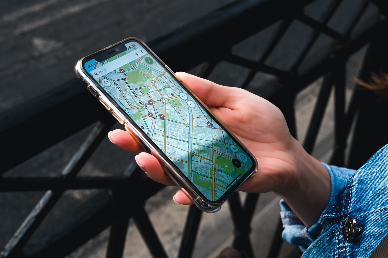 A person finding a business on Google Maps on a smartphone
